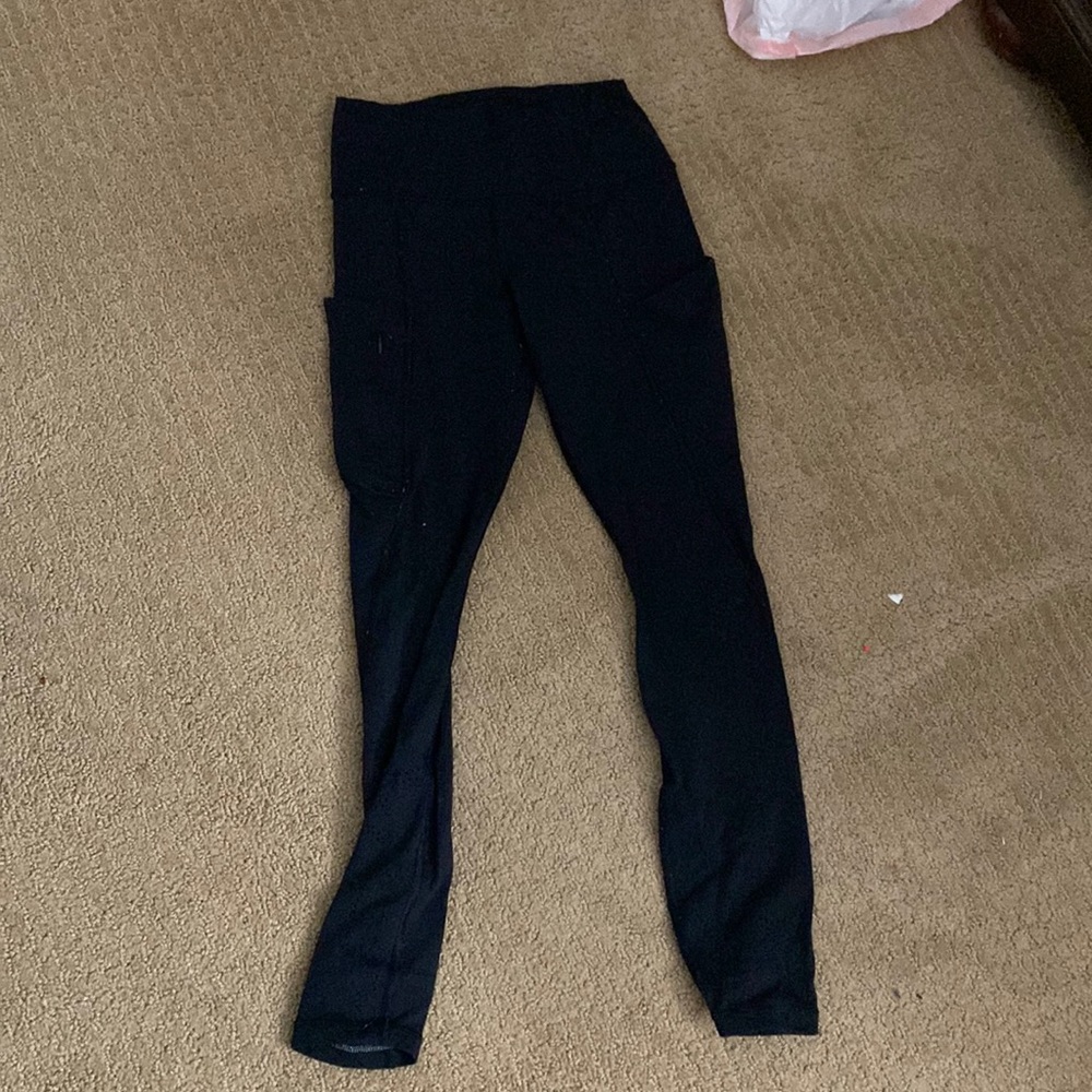 Black Athleta leggings with breathing holes in them  and pockets